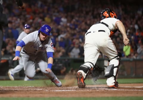 SAN FRANCISCO, CA – JULY 10: Ian Happ #8 of the Chicago Cubs slides safely past Nick Hundley #5 of the San Francisco Giants to score on a hit by Victor Caratini #7 of the Chicago Cubs in the seventh inning at AT&T Park on July 10, 2018 in San Francisco, California. (Photo by Ezra Shaw/Getty Images)