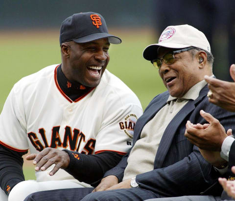 SF Giants slugger Barry Bonds laughs with godfather Giants legend Willie Mays at Giants Opening Day against the San Diego Padres in 2002. (JOHN G. MABANGLO/AFP via Getty Images)