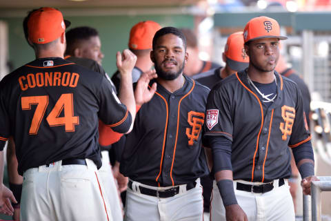 SF Giants top prospect center fielder Heliot Ramos (center) is greeted in the dugout after scoring a run during a Spring Training game against the Texas Rangers during the 2019 preseason. (Orlando Ramirez – USA TODAY Sports)