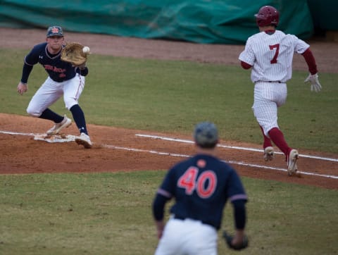 Auburn’s Garrett Wade (40) throws the ball to Auburn’s Rankin Woley (4) before Alabama’s Brett Auerbach (7) makes it to first base during the Auburn-Alabama Capital City Classic at Riverfront Park in Montgomery, Ala., on Tuesday, March 26, 2019. Alabama defeated Auburn 6-3. The SF Giants signed Auerbach as an NDFA last summer.