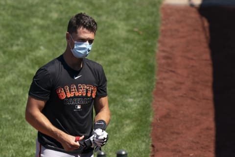 SF Giants catcher Buster Posey (28) puts on batting gloves during a Spring Training workout at Oracle Park before opting out of the 2020 season. (Kyle Terada-USA TODAY Sports)