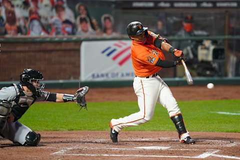 SF Giants second baseman Donovan Solano (right) hits a RBI-single against Arizona Diamondbacks catcher Daulton Varsho (left) during the third inning at Oracle Park. (Kyle Terada-USA TODAY Sports)