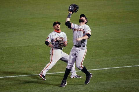 SF Giants first baseman Brandon Belt catches a pop up in foul territory beside Donovan Solano at the Oakland Coliseum. (Stan Szeto-USA TODAY Sports)