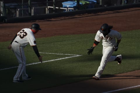 SF Giants shortstop Brandon Crawford (right) is congratulated by third base coach Ron Wotus (23) for hitting a solo home run against the San Diego Padres during the second inning of game one of a doubleheader at Oracle Park. (Kyle Terada-USA TODAY Sports)