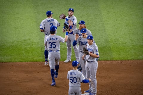 Los Angeles Dodgers right fielder Mookie Betts (50), center fielder Cody Bellinger (35), left fielder Chris Taylor (3), shortstop Corey Seager (5), third baseman Justin Turner (10), and first baseman Max Muncy (13) celebrate the win over the Tampa Bay Rays in game five of the 2020 World Series at Globe Life Field. (Jerome Miron-USA TODAY Sports)