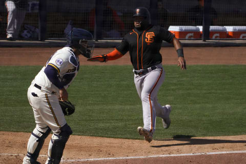 SF Giants outfielder Heliot Ramos (80) scores a run in front of Milwaukee Brewers catcher Omar Narvaez (10) during a spring training game at American Family Fields of Phoenix. (Rick Scuteri-USA TODAY Sports)