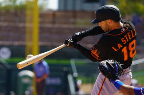 Mar 21, 2021; Phoenix, Arizona, USA; SF Giants infielder Tommy La Stella (18) hits a single in the third against the Los Angeles Dodgers during a Spring Training game at Camelback Ranch, Glendale. (Allan Henry-USA TODAY Sports)