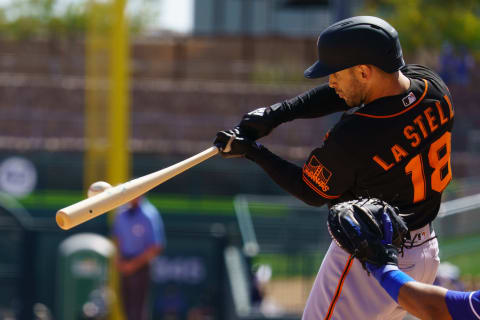 Mar 21, 2021; Phoenix, Arizona, USA; SF Giants infielder Tommy La Stella (18) hits a single in the third against the Los Angeles Dodgers during a Spring Training game at Camelback Ranch Glendale. (Allan Henry-USA TODAY Sports)