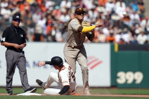 San Diego Padres third baseman Manny Machado (13) throws to first base to complete a double play after forcing out SF Giants right fielder Mike Yastrzemski (5) during the eighth inning at Oracle Park. (Darren Yamashita-USA TODAY Sports)