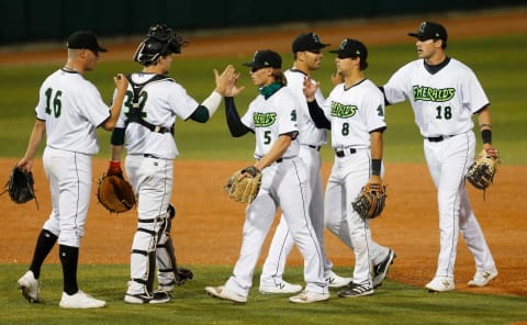 Eugene Emeralds players celebrate their win over the Hillsboro Hops in their first home game of the 2021 season at PK Park in Eugene.