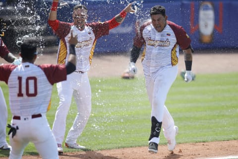 Jun 1, 2021; St. Lucie, Florida, USA; Venezuela right fielder Diego Rincones (30) celebrates with teammates at home plate after connecting for a home run in the tenth inning to win the game against Colombia during the WBSC Baseball Americas Qualifier series at Clover Park. Rincones is an outfielder in the SF Giants organization. (Sam Navarro-USA TODAY Sports)