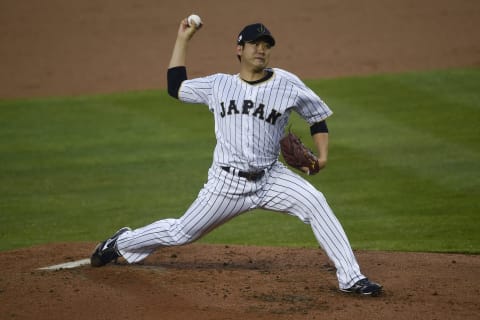 Japan starting pitcher Tomoyuki Sugano (11) pitches against the United States during the second inning of the 2017 World Baseball Classic at Dodger Stadium. (Kelvin Kuo-USA TODAY Sports)