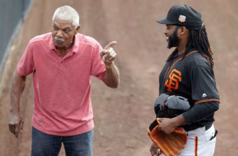 Feb 18, 2016; Scottsdale, AZ, USA; San Francisco Giants former player Felipe Alou (L) talks to pitcher Johnny Cueto (47) during spring training camp at Scottsdale Stadium. Mandatory Credit: Rick Scuteri-USA TODAY Sports