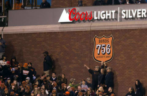 Apr 22, 2016; San Francisco, CA, USA; San Francisco Giants fans pose under a sign to recognize former Giants player and current Miami Marlins hitting coach Barry Bonds (25) record breaking 756 home runs during the third inning at AT&T Park. Mandatory Credit: Kelley L Cox-USA TODAY Sports