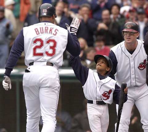 Cleveland Indians DH Ellis Burks (L) is congratulated at home plate by his son Christopher (C) as teammate Jim Thome watches after Burks hit a two run home run during the first inning against the Minnesota Twins on 08 April, 2002 at Jacobs Field in Cleveland, OH. Cleveland defeated Minnesota 9-5. AFP PHOTO/David MAXWELL (Photo by DAVID MAXWELL / AFP) (Photo credit should read DAVID MAXWELL/AFP via Getty Images)