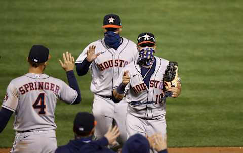 OAKLAND, CALIFORNIA – SEPTEMBER 08: Yuli Gurriel #10 and Abraham Toro #31 of the Houston Astros are congratulated by teammates after they beat the Oakland Athletics in the second game of their double header at RingCentral Coliseum on September 08, 2020 in Oakland, California. (Photo by Ezra Shaw/Getty Images)