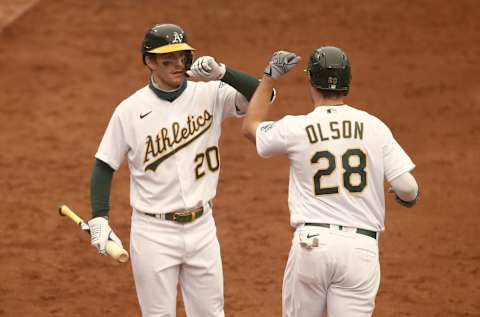 OAKLAND, CALIFORNIA – SEPTEMBER 10: Matt Olson #28 of the Oakland Athletics is congratulated by Mark Canha #20 after he hit a two-run home run against the Houston Astros in the sixth inning at RingCentral Coliseum on September 10, 2020 in Oakland, California. (Photo by Ezra Shaw/Getty Images)