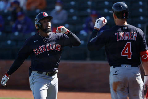 Daniel Johnson #23 of the Cleveland Indians high fives Bradley Zimmer #4 (Photo by Christian Petersen/Getty Images)