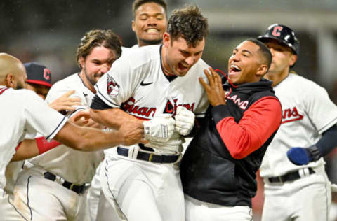 CLEVELAND, OHIO – JUNE 10: Luke Maile #12 of the Cleveland Guardians celebrates with teammates after hitting a walk-off sacrifice fly to defeat the Oakland Athletics at Progressive Field on June 10, 2022 in Cleveland, Ohio. The Guardians defeated the Athletics 3-2. (Photo by Jason Miller/Getty Images)