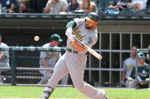 Jun 25, 2017; Chicago, IL, USA; Oakland Athletics first baseman Yonder Alonso (17) hits a single during the seventh inning against the Chicago White Sox at Guaranteed Rate Field. Mandatory Credit: Dennis Wierzbicki-USA TODAY Sports