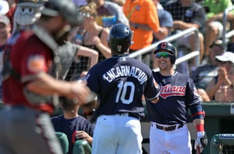 Mar 19, 2017; Goodyear, AZ, USA; Cleveland Indians third baseman Giovanny Urshela (right) congratulates third baseman Edwin Encarnacion (10) after Encarnacion scored during the fourth inning against the Arizona Diamondbacks at Goodyear Ballpark. Mandatory Credit: Jake Roth-USA TODAY Sports