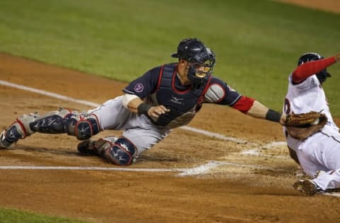 Sep 24, 2015; Minneapolis, MN, USA; Cleveland Indians catcher Yan Gomes (10) tags out Minnesota Twins center fielder Aaron Hicks (32) in the first inning at Target Field. Mandatory Credit: Bruce Kluckhohn-USA TODAY Sports