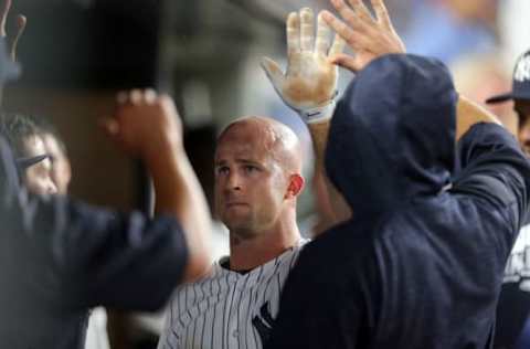 Jun 27, 2016; Bronx, NY, USA; New York Yankees left fielder Brett Gardner (11) is congratulated in the dugout after scoring against the Texas Rangers during the fifth inning at Yankee Stadium. Mandatory Credit: Brad Penner-USA TODAY Sports