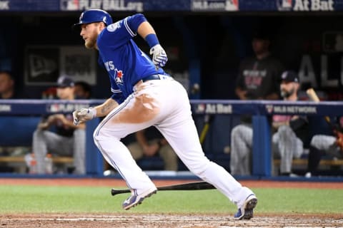 Oct 18, 2016; Toronto, Ontario, CAN; Toronto Blue Jays left fielder Michael Saunders (21) hits a single during the sixth inning against the Cleveland Indians in game four of the 2016 ALCS playoff baseball series at Rogers Centre. Mandatory Credit: Nick Turchiaro-USA TODAY Sports