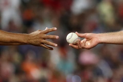 BALTIMORE, MD – AUGUST 10: Starting pitcher Nathan Eovaldi #17 of the Boston Red Sox (R) hands the ball to manager Alex Cora #20 of the Boston Red Sox as he is relieved in the third inning against the Baltimore Orioles at Oriole Park at Camden Yards on August 10, 2018 in Baltimore, Maryland. (Photo by Patrick Smith/Getty Images)