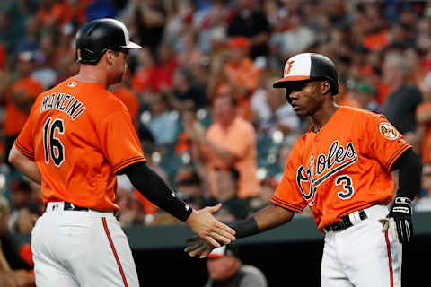 BALTIMORE, MD – AUGUST 11: Trey Mancini #16 of the Baltimore Orioles celebrates with Cedric Mullins #3 after scoring a run on a double by Renato Nunez #39 (not pictured) in the second inning against the Boston Red Sox during game two of a doubleheader at Oriole Park at Camden Yards on August 11, 2018 in Baltimore, Maryland. (Photo by Patrick McDermott/Getty Images)