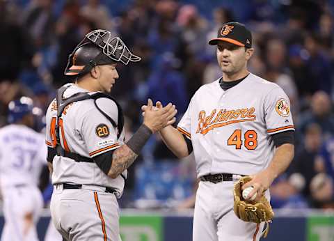 TORONTO, ON – APRIL 01: Richard Bleier #48 of the Baltimore Orioles celebrates their victory with Jesus Sucre #40 during MLB game action against the Toronto Blue Jays at Rogers Centre on April 1, 2019 in Toronto, Canada. (Photo by Tom Szczerbowski/Getty Images)