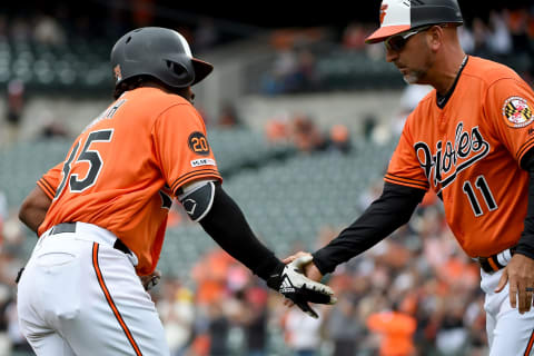 BALTIMORE, MD – MAY 11: Dwight Smith Jr. #35 of the Baltimore Orioles celebrates with third base coach Jose David Flores #11 after hitting a home run against the Los Angeles Angels during the first inning at Oriole Park at Camden Yards on May 11, 2019 in Baltimore, Maryland. (Photo by Will Newton/Getty Images)