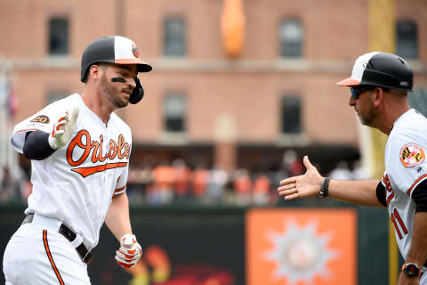 BALTIMORE, MD – JUNE 02: Trey Mancini #16 of the Baltimore Orioles celebrates with third base coach Jose David Flores #11 after hitting a home run during the first inning against the San Francisco Giants at Oriole Park at Camden Yards on June 2, 2019 in Baltimore, Maryland. (Photo by Will Newton/Getty Images)