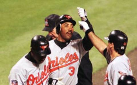 Baltimore Orioles Harold Baines (C) is greeted by teammates Rafael Palmeiro (R) and Geronimo Berroa (L) after hitting a two-run home run in the third inning of game four of the American League Championship Series against the Cleveland Indians at Jacobs Field in Cleveland, OH, 12 October. The Indians have a 2-1 lead in the series. AFP PHOTO/Timothy CLARY (Photo by Timothy A. CLARY / AFP) (Photo credit should read TIMOTHY A. CLARY/AFP via Getty Images)