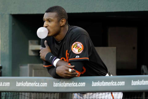 BALTIMORE, MD – JUNE 03: Adam Jones #10 of the Baltimore Orioles blows a bubble while watching the second inning from the dugout against the Toronto Blue Jays at Oriole Park at Camden Yards on June 3, 2011 in Baltimore, Maryland. (Photo by Rob Carr/Getty Images)