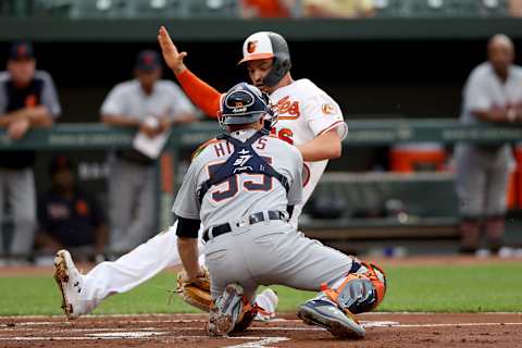 BALTIMORE, MARYLAND – MAY 29: Trey Mancini #16 of the Baltimore Orioles comes in to score in front of catcher John Hicks #55 of the Detroit Tigers in the first inning at Oriole Park at Camden Yards on May 29, 2019 in Baltimore, Maryland. (Photo by Rob Carr/Getty Images)