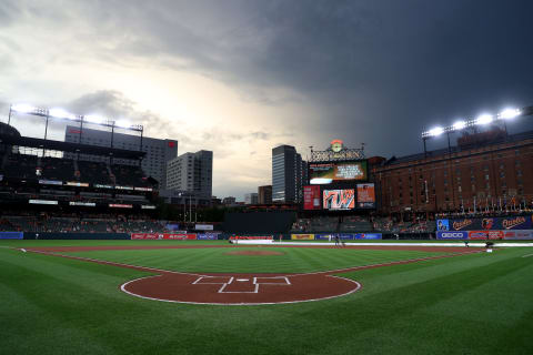 BALTIMORE, MARYLAND – JULY 17: The grounds crew removes the tarp before the start of the rained delayed Washington Nationals and Baltimore Orioles game at Oriole Park at Camden Yards on July 17, 2019 in Baltimore, Maryland. (Photo by Rob Carr/Getty Images)