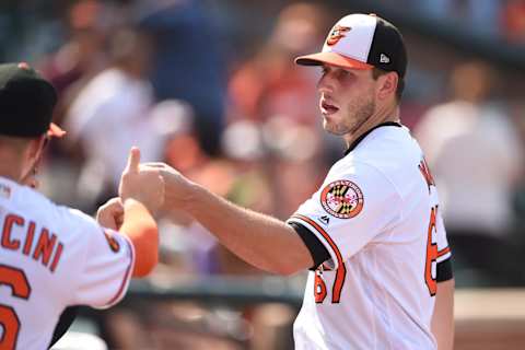 BALTIMORE, MD – SEPTEMBER 22: John Means #67 of the Baltimore Orioles in congratulated for his performance in the seventh inning during a baseball game against the Seattle Mariners at Oriole Park at Camden Yards on September 22, 2019 in Baltimore, Maryland. (Photo by Mitchell Layton/Getty Images)