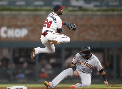 ATLANTA, GEORGIA – SEPTEMBER 21: Second baseman Adeiny Hechavarria #24 of the Atlanta Braves turns a double play over second baseman Cristhian Adames #14 of the San Francisco Giants in the fifth inning during the game at SunTrust Park on September 21, 2019 in Atlanta, Georgia. (Photo by Mike Zarrilli/Getty Images)