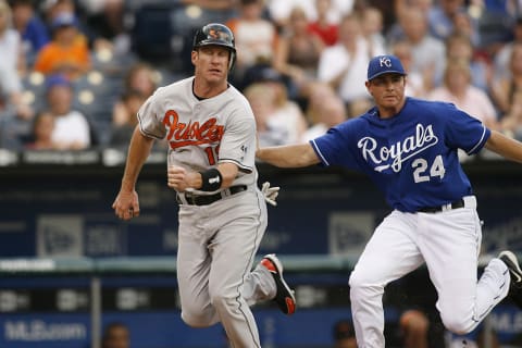 Mark Teahen of the Royals gets Jeff Conine during a run down in action between the Baltimore Orioles and Kansas City Royals at Kauffman Stadium in Kansas City, Missouri on July 26, 2006. Baltimore won 4-3. (Photo by G. N. Lowrance/Getty Images)