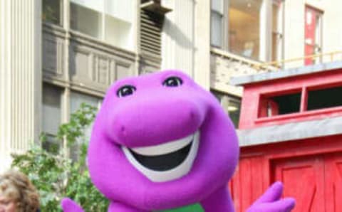 NEW YORK – NOVEMBER 28: Barney the dinosaur rides on a float at the 76th Annual Macy’s Thanksgiving Day Parade in Herald Square November 28, 2002 in New York City. (Photo by Matthew Peyton/Getty Images)