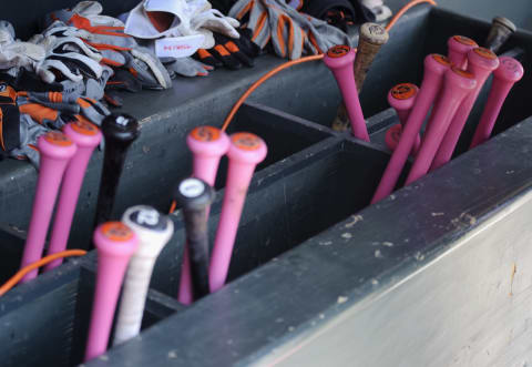 The pink bats used by the Baltimore Orioles are seen in the dugout before a Mother’s Day game. (Photo by Hannah Foslien/Getty Images)