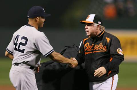 BALTIMORE, MD – SEPTEMBER 12: Pitcher Mariano Rivera #42 of the New York Yankees shakes hands with manager Buck Showalter of the Baltimore Orioles while being honored during a pregame ceremony before the start the Yankees and Orioles game at Oriole Park at Camden Yards on September 12, 2013 in Baltimore, Maryland. Mariano, who is retiring at the end of the season, made his last appearance at Camden Yards. (Photo by Rob Carr/Getty Images)