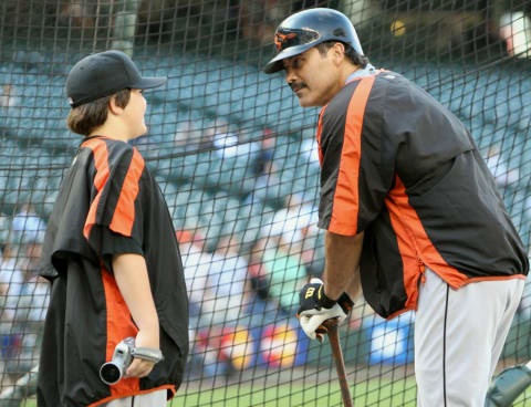 SEATTLE – JULY 14: Infielder Rafael Palmeiro #25 of the Baltimore Orioles talks to his son, Preston, during practice for the game against the Seattle Mariners on July 14, 2005 at Safeco Field in Seattle Washington. The Orioles won 5-3. (Photo by Otto Greule Jr/Getty Images)