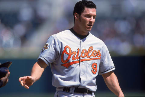 26 Apr 2001: Brady Anderson #9 of the Baltimore Orioles hands off his batting helmet during the game against the Detroit Tigers at Comerica Park in Detroit, Michigan. The Tigers defeated the Orioles 8-2.Mandatory Credit: Tom Pigeon /Allsport