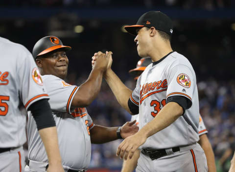 TORONTO, ON – JUNE 29: Ubaldo Jimenez #31 of the Baltimore Orioles is congratulated on their victory by first base coach Wayne Kirby #21 during MLB game action against the Toronto Blue Jays at Rogers Centre on June 29, 2017 in Toronto, Canada. (Photo by Tom Szczerbowski/Getty Images)