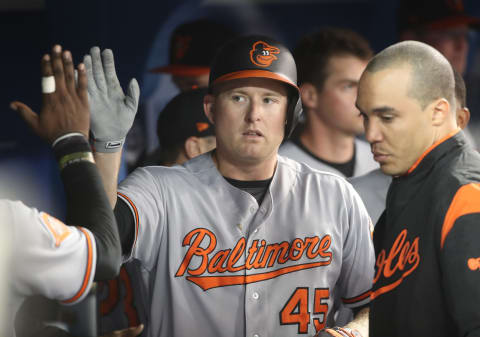 TORONTO, ON – SEPTEMBER 11: Mark Trumbo #45 of the Baltimore Orioles is congratulated by teammates in the dugout after hitting a solo home run in the fifth inning during MLB game action as Marco Estrada #25 of the Toronto Blue Jays reacts at Rogers Centre on September 11, 2017 in Toronto, Canada. (Photo by Tom Szczerbowski/Getty Images)