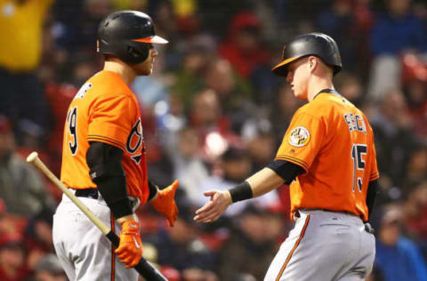 BOSTON, MA – MAY 19: Chance Sisco #15 of the Baltimore Orioles celebrates with Chris Davis #19 after scoring in the third inning at Fenway Park on May 19, 2018 in Boston, Massachusetts. (Photo by Adam Glanzman/Getty Images)