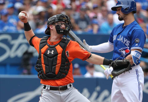 TORONTO, ON – JUNE 9: Chance Sisco #15 of the Baltimore Orioles throws out Kevin Pillar #11 of the Toronto Blue Jays who is thrown out attempting to steal second base in the second inning during MLB game action at Rogers Centre on June 9, 2018 in Toronto, Canada. (Photo by Tom Szczerbowski/Getty Images)