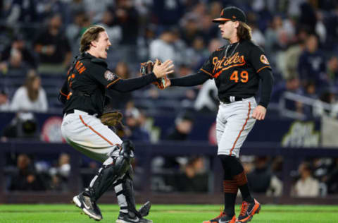 NEW YORK, NEW YORK – SEPTEMBER 30: Adley Rutschman #35 and DL Hall #49 of the Baltimore Orioles celebrate the win over the New York Yankees at Yankee Stadium on September 30, 2022 in the Bronx borough of New York City. The Baltimore Orioles defeated the New York Yankees 2-1. (Photo by Elsa/Getty Images)